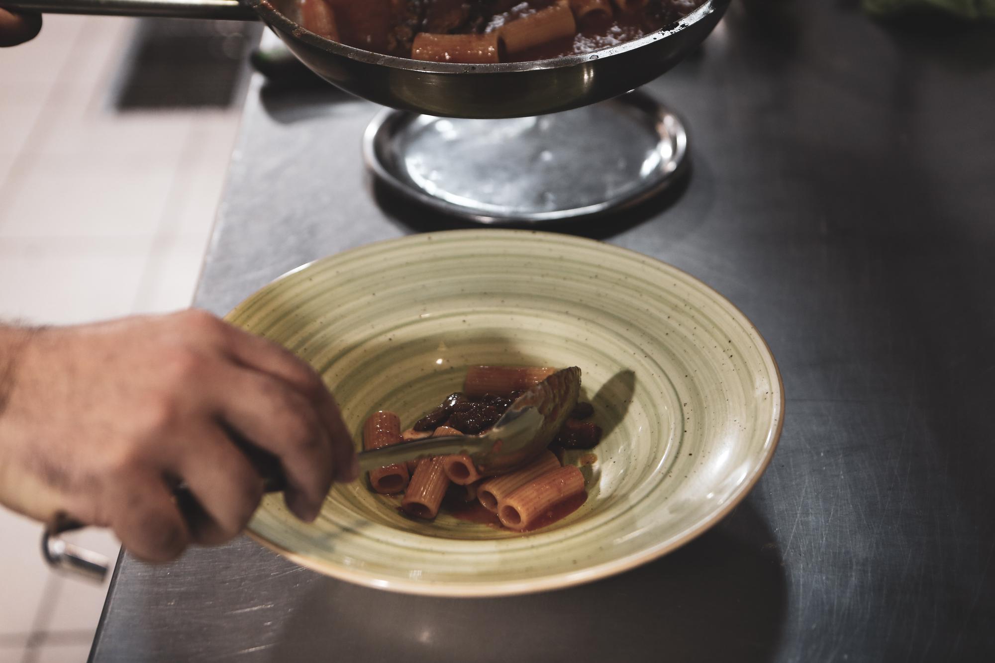 chef arranging a plated dish on a calm ceramic plate